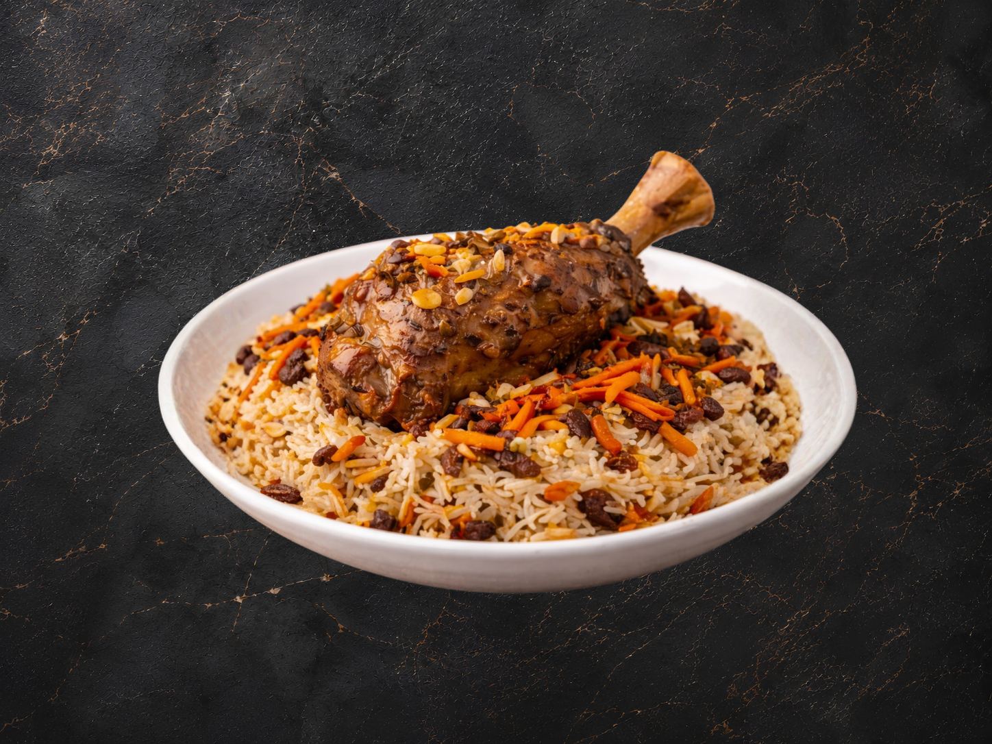 Qabuli rice with lamb shank, carrots and raisins